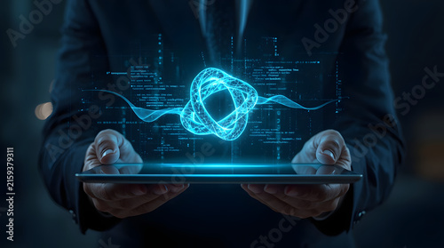 Businessman holding tablet with futuristic hologram data interface representing digital transformation and advanced technology
