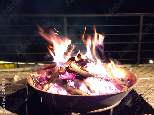 Fire Pit With Bright Flames and White Hot Ash at Night