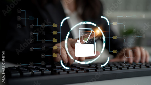 Business Professional Engaging with Digital File Management System at a Modern Workspace with Futuristic Interface Overlay. Sentient.
