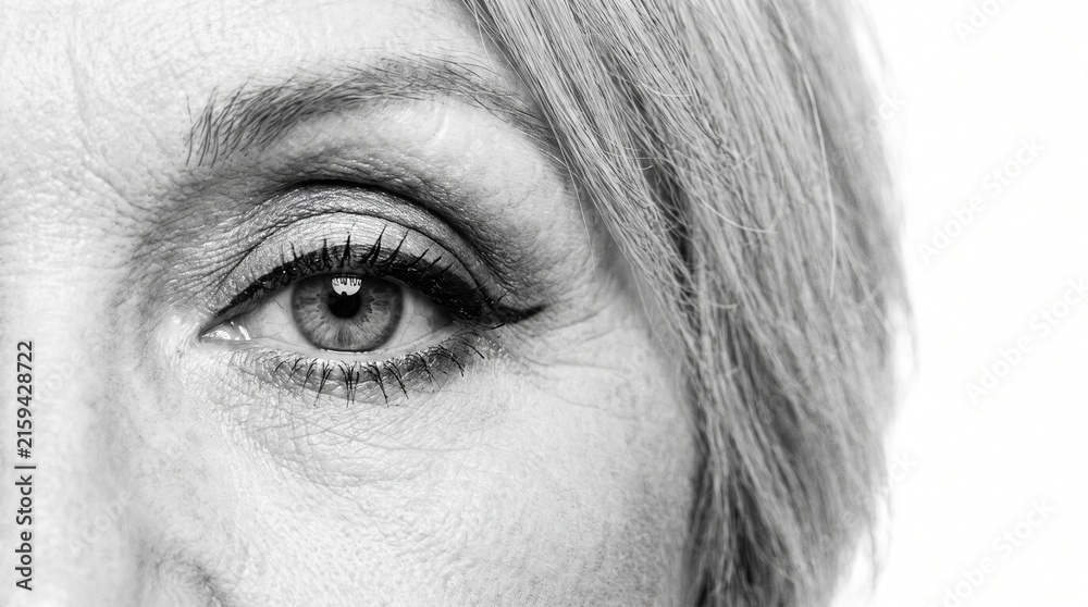 Fototapeta premium Black and White Macro Close Up of Senior Woman Eye with Makeup and Fine Lines