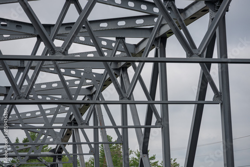 фотографія a low-angle, close-up view of the intricate gray painted structural steel truss