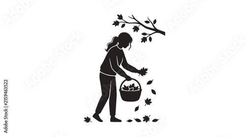 Silhouette of a woman gathering fallen autumn leaves in a basket