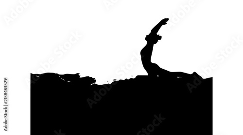 Silhouette of a woman practicing a yoga pose