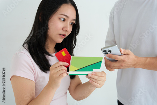 Young Japanese Couple Holding Bankbook and Credit Card at Home