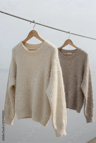 Minimalist Scandinavian Knit Sweaters Hanging on Clothesline Outdoors with Soft Neutral Earth Tones Cozy Winter Fashion Sustainable Lifestyle and Premium Textile Craftsmanship