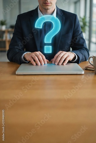 Man in suit with glowing question mark over laptop