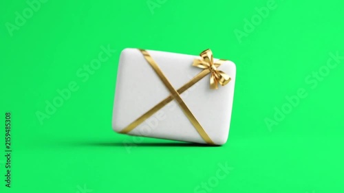 Realistic white gift box with ribbon on green background.