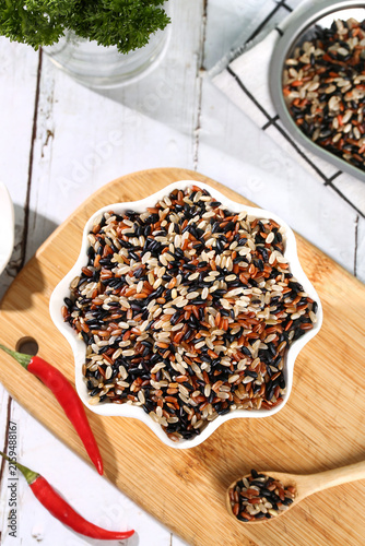 Organic Mixed Rice Varieties in Star Bowl - Brown Black Red Wild Rice Grains on Wooden Board