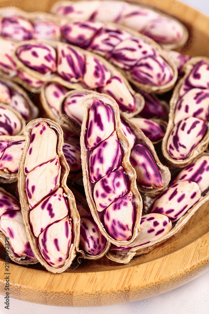 Fototapeta premium Fresh Purple Striped Peanuts from Yunnan Plateau in Wooden Bowl - Natural Healthy Legumes