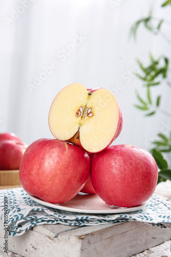 Fresh Red Fuji Apples with Cut Half on White Plate - Healthy Fruit Photography