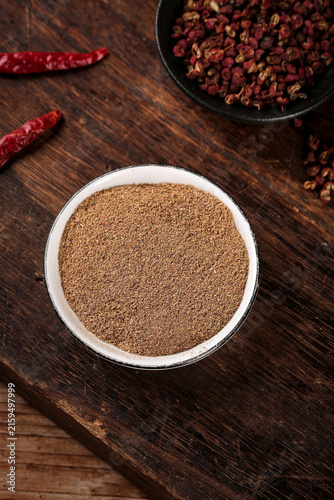 Fotografie Ground spice powder with red chilies and peppercorns on wooden table for barbecu