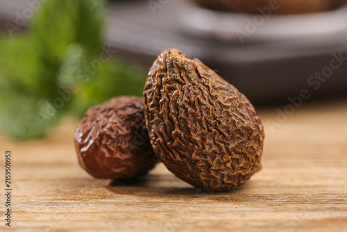 Obraz na plátně Black walnuts on wooden cutting board - healthy natural food ingredient with she