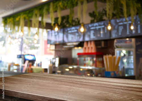 Картината върху платно wooden table for placing products with a beautiful night restaurant backdrop, Space for placing items on the table, product and food display