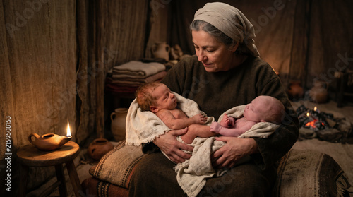 The birth of twins Esau and Jacob. The infant Jacob's tiny hand firmly grasping the heel of his incredibly hairy brother Esau
