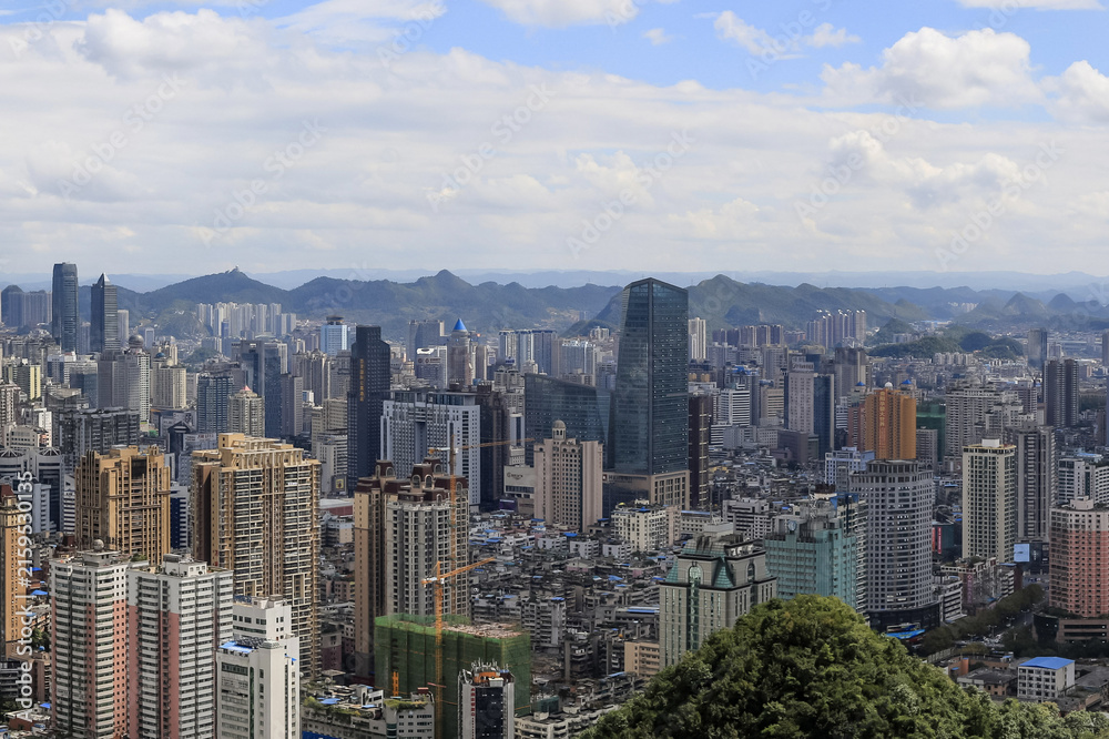 Fototapeta premium Asian City Skyline with Mountains - Urban Landscape Panorama
