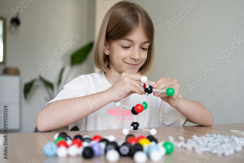 girl making molecular model learning chemistry science, home education. STEM 