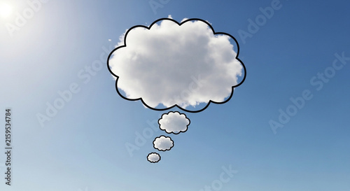 Thought bubble shape formed by a real cloud against a bright clear blue sky background.
