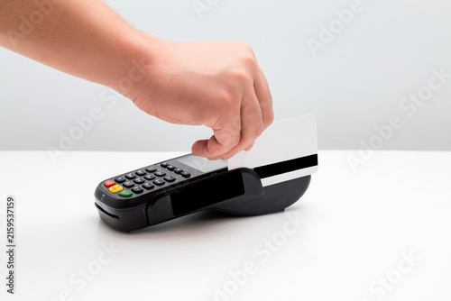 Canvastavla Hand swiping payment card on card reader terminal for cashless transaction