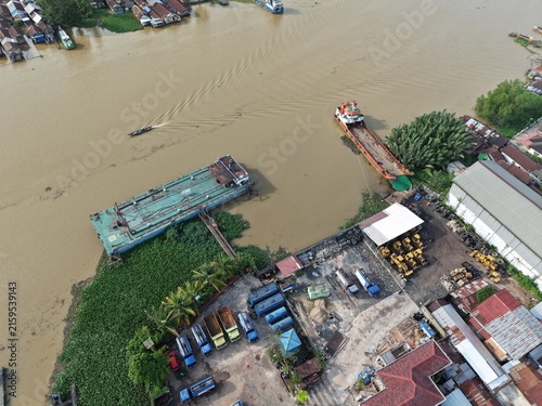 Принти на полотні Aerial view of oil tankers and heavy equipment ferry boats parked on the riverba