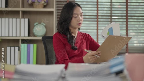 Asian businesswoman signing documents in the office