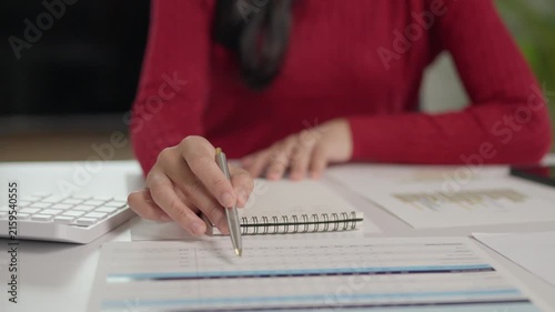Financial analyst examining business report document