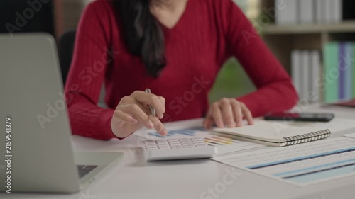 Accountant calculating business budget and taking notes