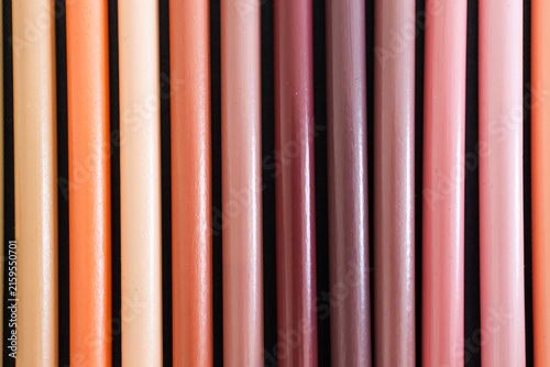 close-up of ochre brown and skin tones pencils neatly lined up in pencil case, concept of creativity, drawing, education and art supplies