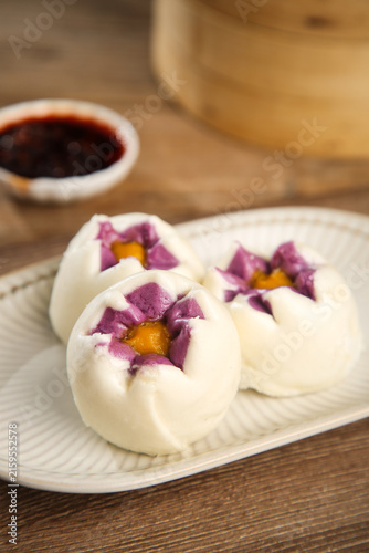 фотографія Asian Steamed Buns with Purple Sweet Potato and Golden Egg Yolk Filling Traditio