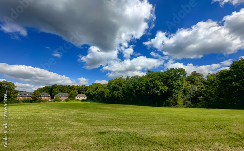 Serene rural panorama, Quiet countryside with cloudy skies and cottages