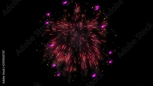 Firework display featuring red and pink sparks explodes outward in the dark night sky during a festive celebration.