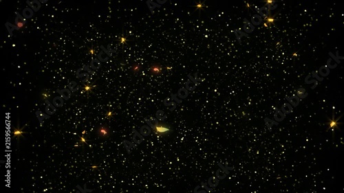 Golden sparkles and tiny glowing dust particles scatter densely across a pitch black background for special effects.