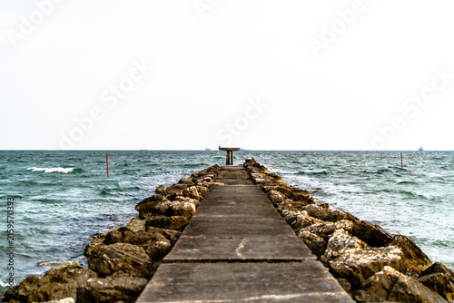 Фотография Rocky Breakwater Extending Into Choppy Coastal Sea
