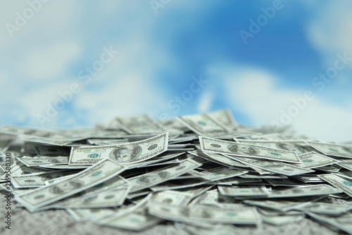 Pile of money with blue sky background. Bright economic future concept