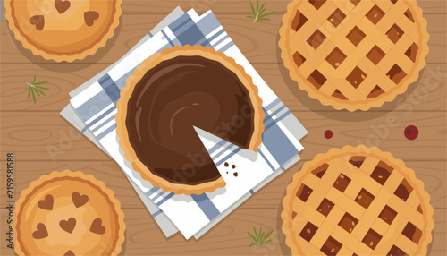 Top down view of freshly baked sweet pies on a wooden table with a sliced chocolate tart placed on a blue striped kitchen napkin.