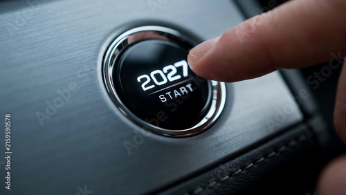 2027 new year concept with finger pressing a start button inside a car
