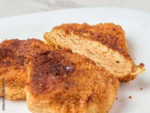 Fried soy cutlets on a white plate, close-up.