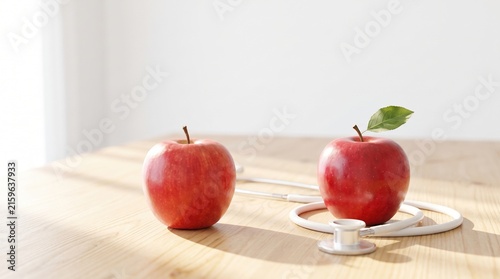 Fresh Red Apples and Medical Stethoscope on Wooden Table with Natural Light