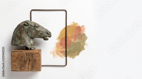 Horse Sculpture on Wooden Base with Colorful Paint Smudge on White Background