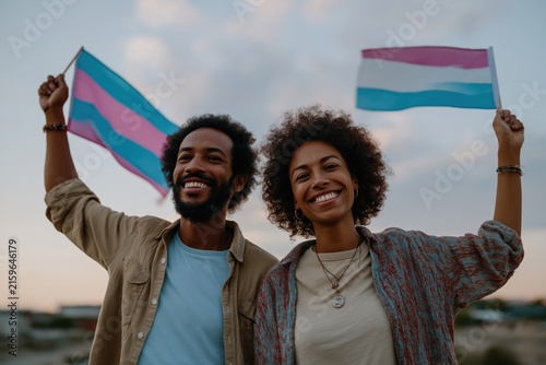 Plakat Diverse couple proudly waves transgender pride flags against a sky background