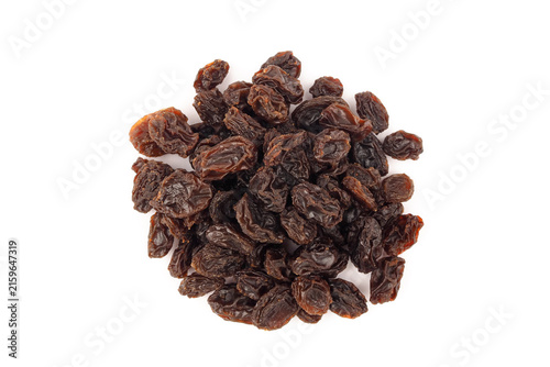 Heap of dried dark raisins isolated on white background top view.