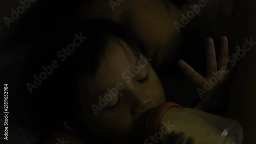 Mom Sleeping While Baby Drinks From Bottle