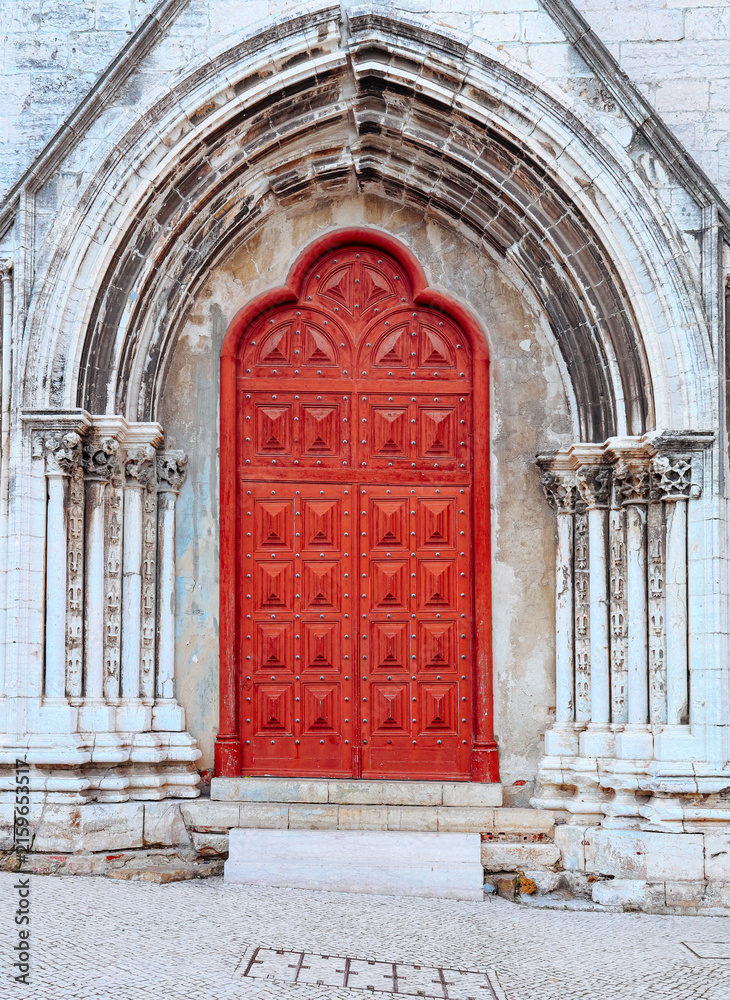 Fototapeta premium Bright red Gothic church door in stone archway