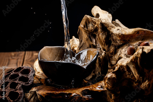 Konstfotografi Pouring clear white liquor into the wine vessels placed on the wooden board creates countless bubbles