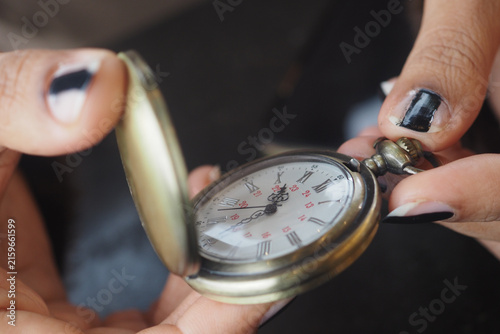 Obraz na płótnie Holding a pocket watch in hands at a close distance