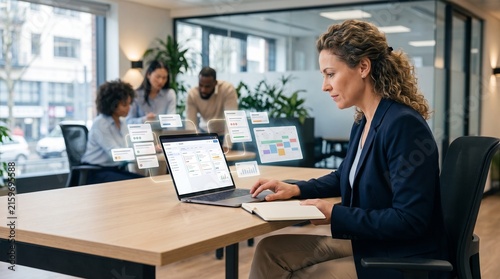 Business Professional Using Project Management Software on Laptop