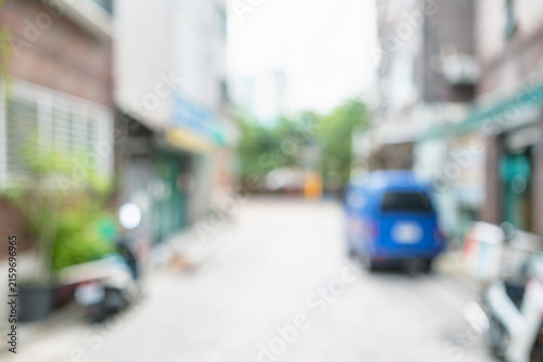 Abstract blurred urban residential street background with parked blue truck