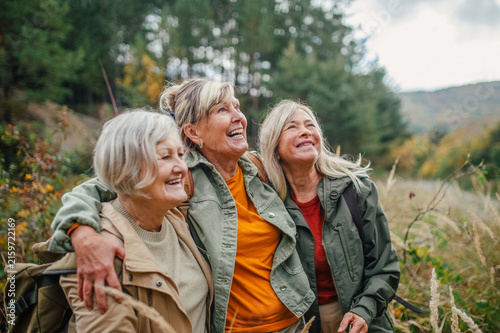 Group of mature female friends enjoying countryside walk.