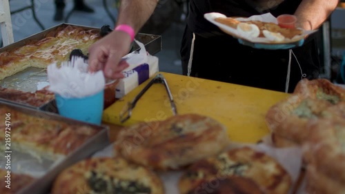 A cook prepares food at an outdoor food court. Street food at food festivals in Israel; a celebration in Haifa. Close-up of street food.