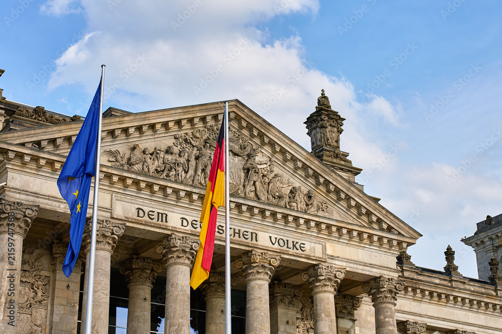 Fototapeta premium Reichstag building and flags in Berlin, Germany