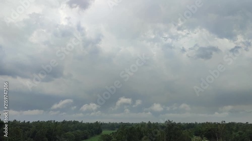 Cloudy Sky Over Green Forest Landscape With Storm Clouds And Distant Agricultural Fields